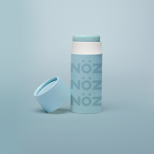 Green Noz sunscreen with lid off and same color background