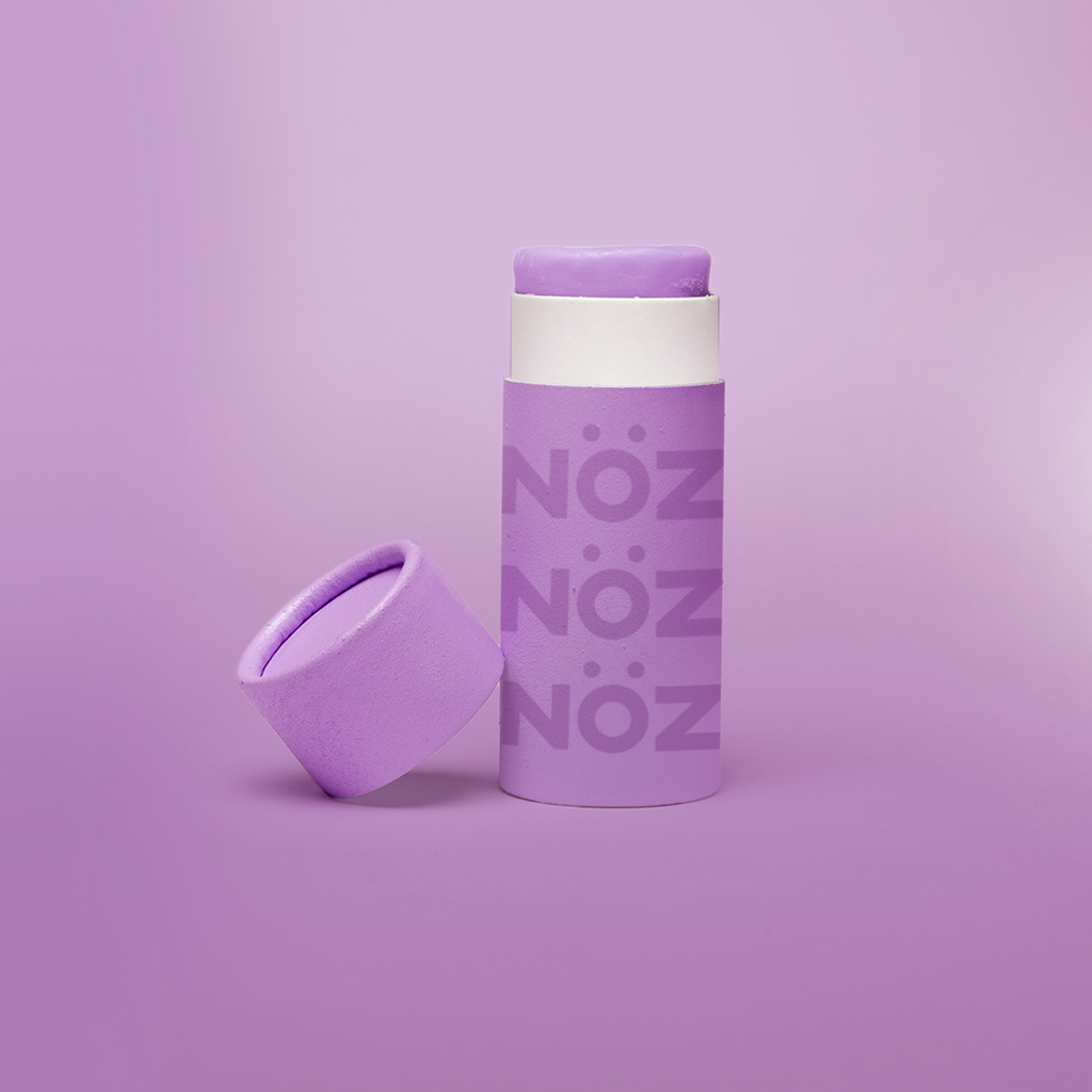 Front view of purple Noz sunscreen with lid off