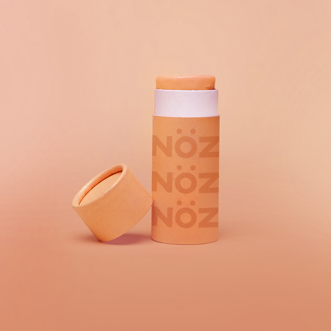 Front view of orange noz sunscreen with cap off