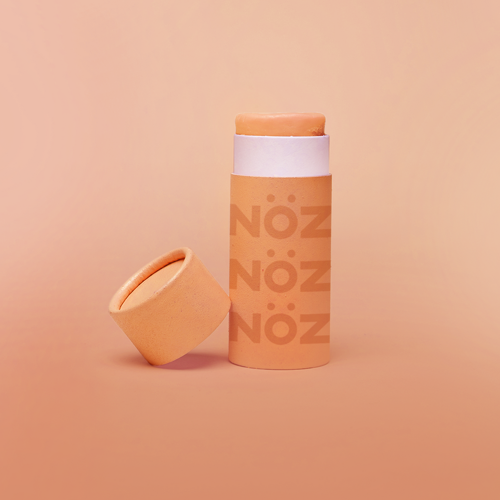 Front view of orange noz sunscreen with cap off