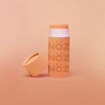 Load image into Gallery viewer, Front view of orange noz sunscreen with cap off
