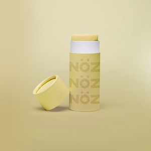 Front view of yellow Noz sunscreen with lid off