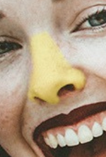 Load image into Gallery viewer, Close-up of woman with yellow Noz sunscreen on nose
